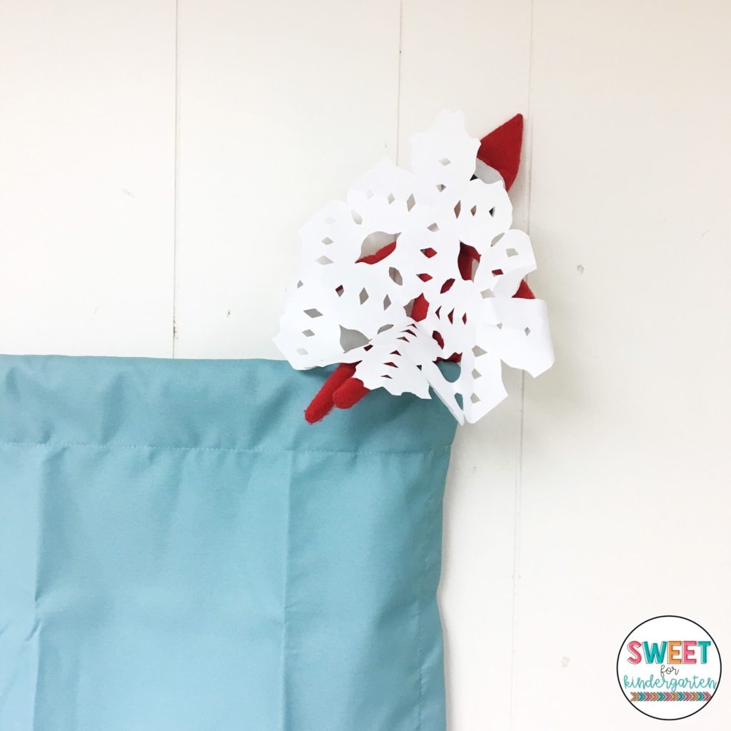 Elf making paper snowflakes