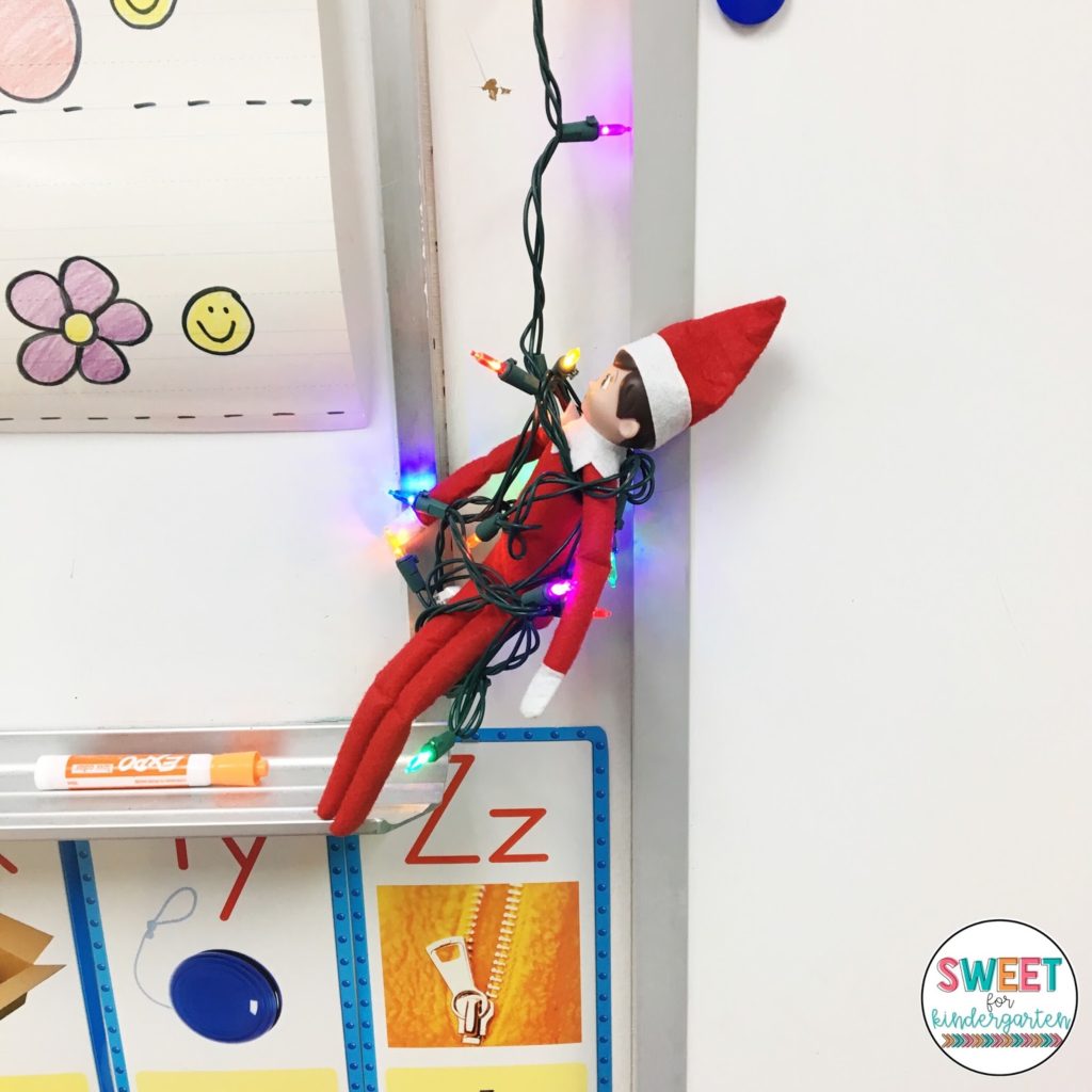 Elf on the Shelf hanging by whiteboard