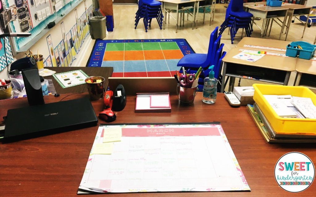 Photo of a clean desk and neat classroom as an example of classroom organization.