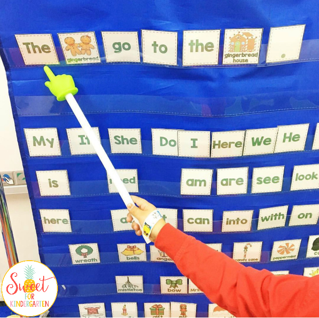 Kindergarten Writing Skills Progression- Student building a complete sentence using word cards and a pocket chart. 