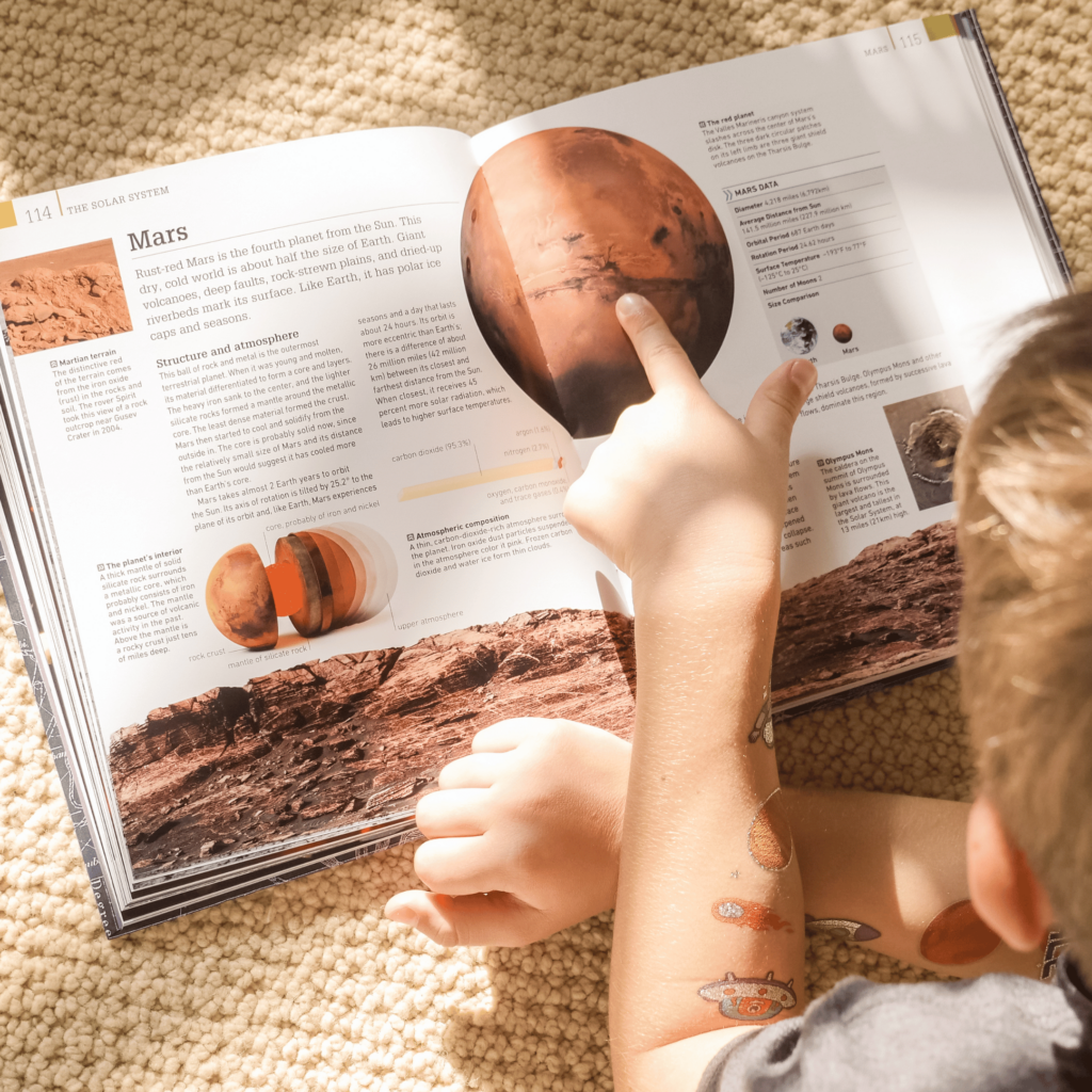 Kid reading textbook practicing syllables for reading development